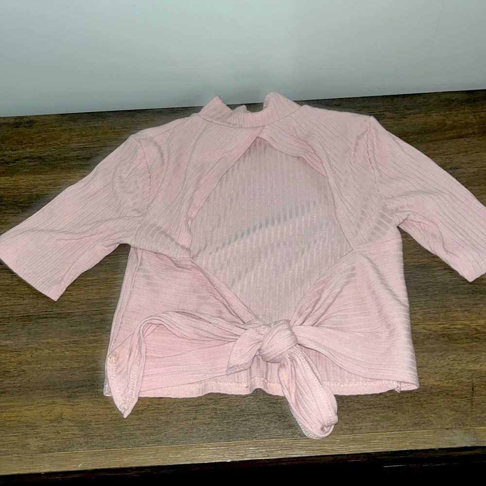 Pink open back cropped tee.